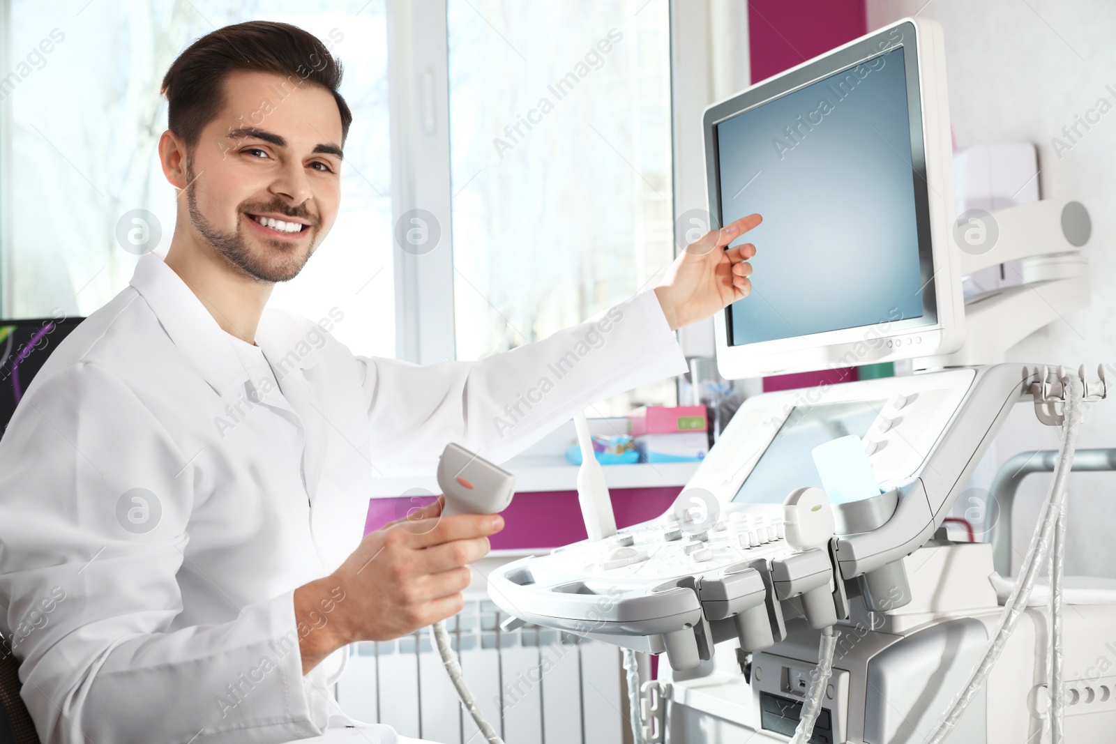 Photo of Sonographer using modern ultrasound machine in clinic