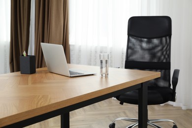 Photo of Director's office with large wooden table and comfortable armchair. Interior design