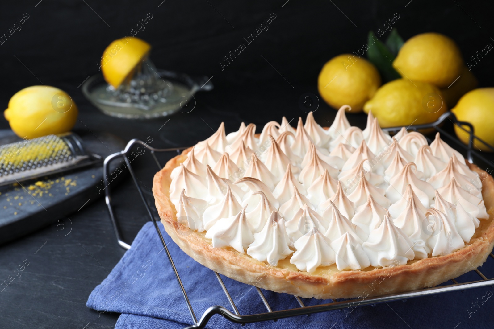 Photo of Delicious lemon meringue pie on black table