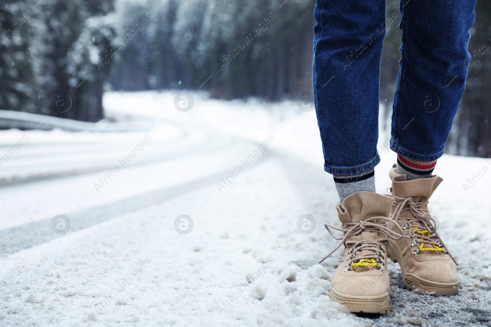 Photo of Woman walking outdoors on snowy winter day. Space for text