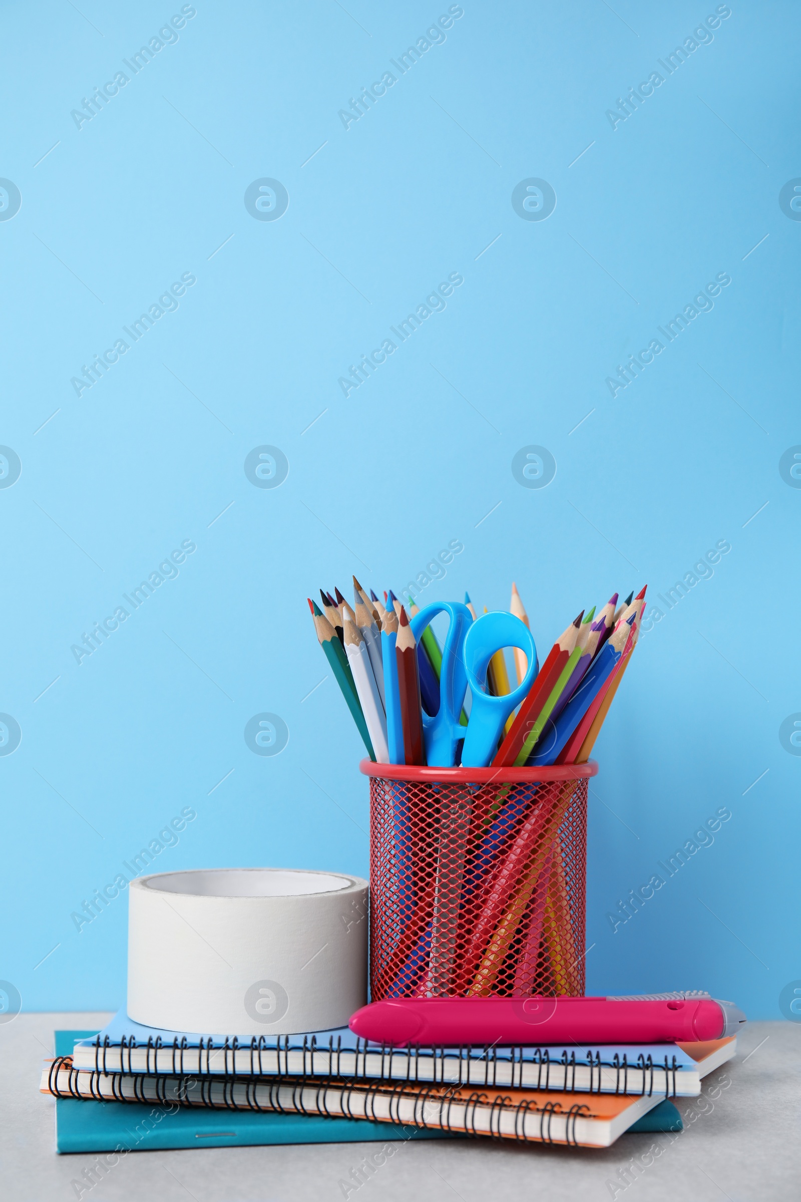 Photo of Different school stationery on table against light blue background. Back to school