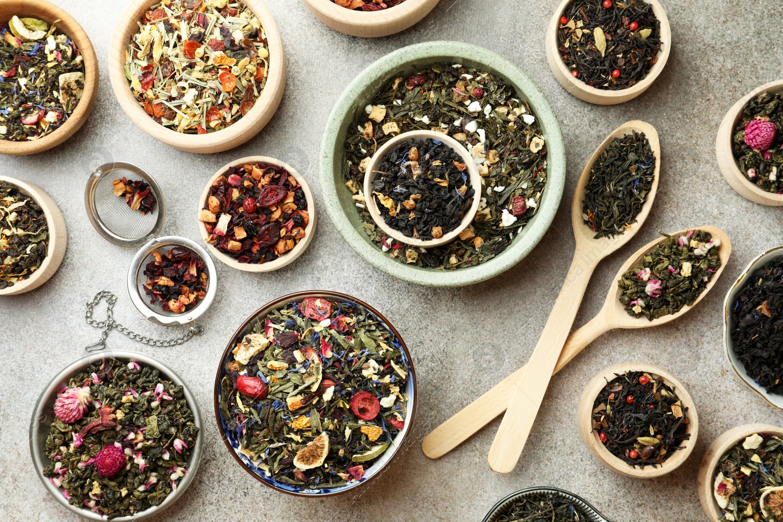 Photo of Many different herbal teas on grey table, flat lay