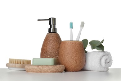 Photo of Bath accessories. Different personal care products and eucalyptus branch on table against white background