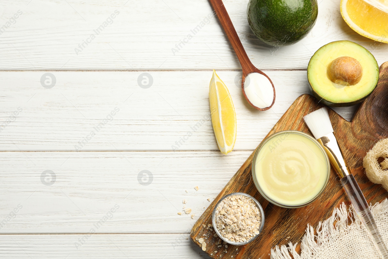 Photo of Flat lay composition with handmade face mask and ingredients on white wooden table. Space for text