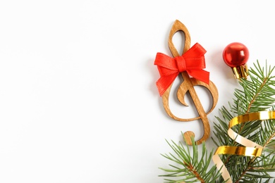 Photo of Wooden treble clef and decorations on white background. Christmas music concept