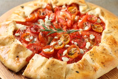 Photo of Tasty galette with tomato, rosemary and cheese (Caprese galette) as background, closeup