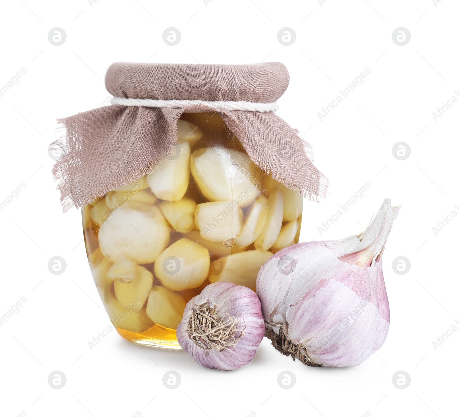 Photo of Garlic with honey in glass jar and fresh bulbs isolated on white