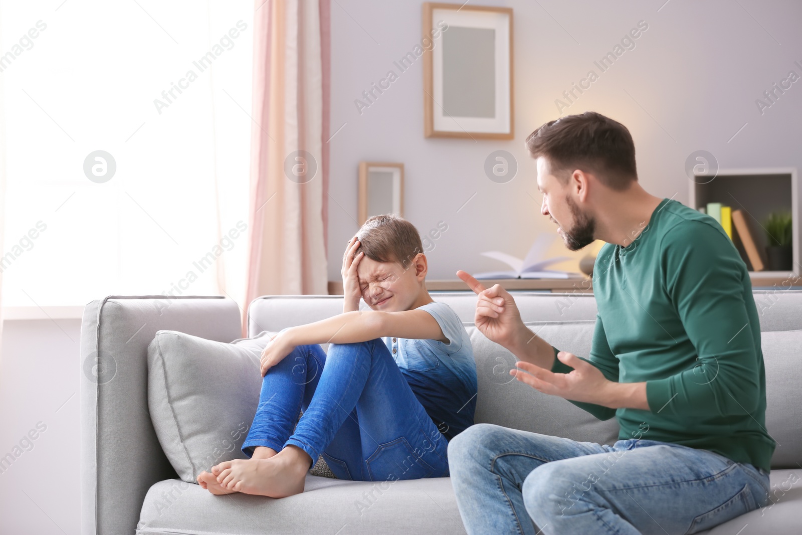 Photo of Father arguing with son at home