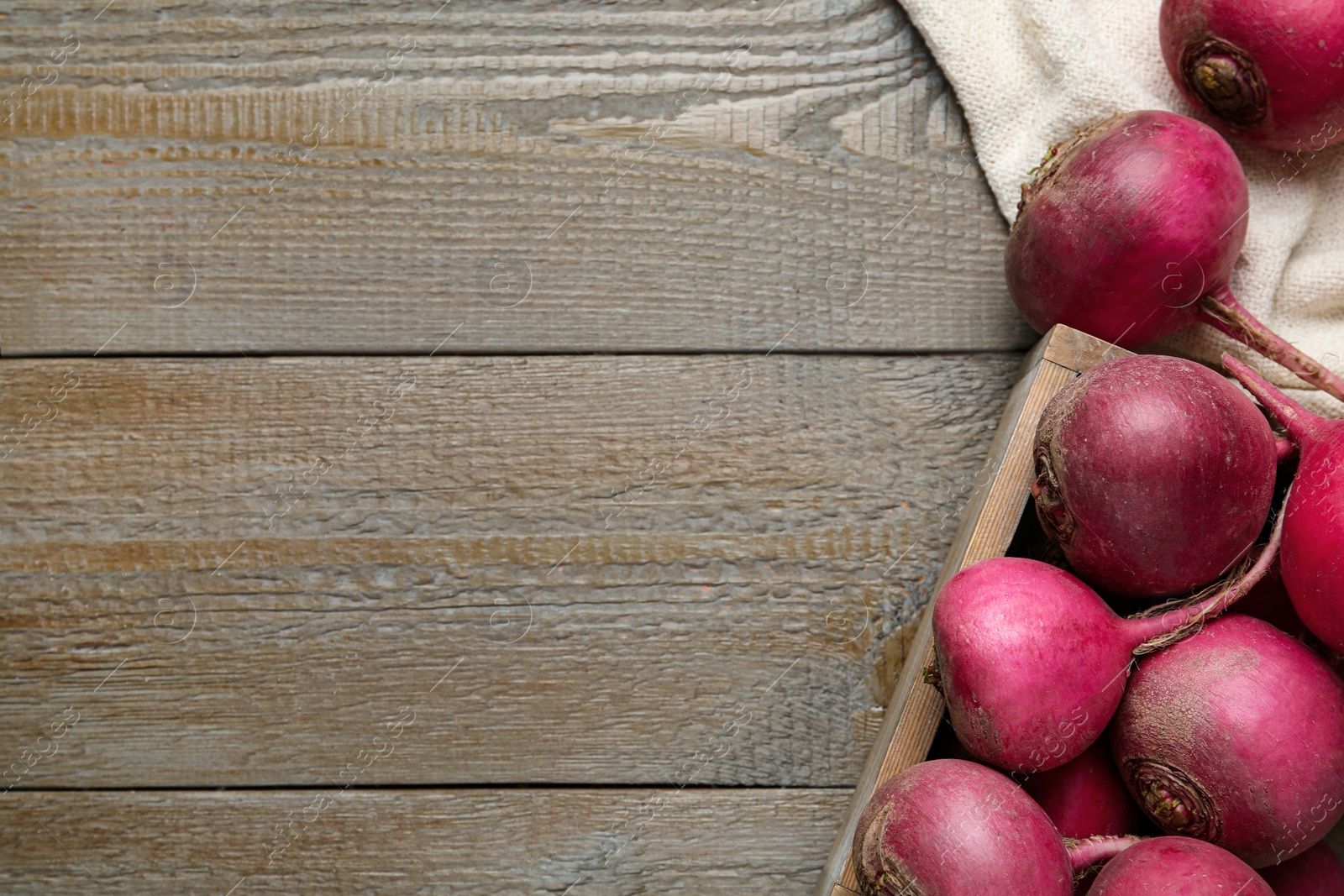 Photo of Red turnips on wooden table, flat lay. Space for text