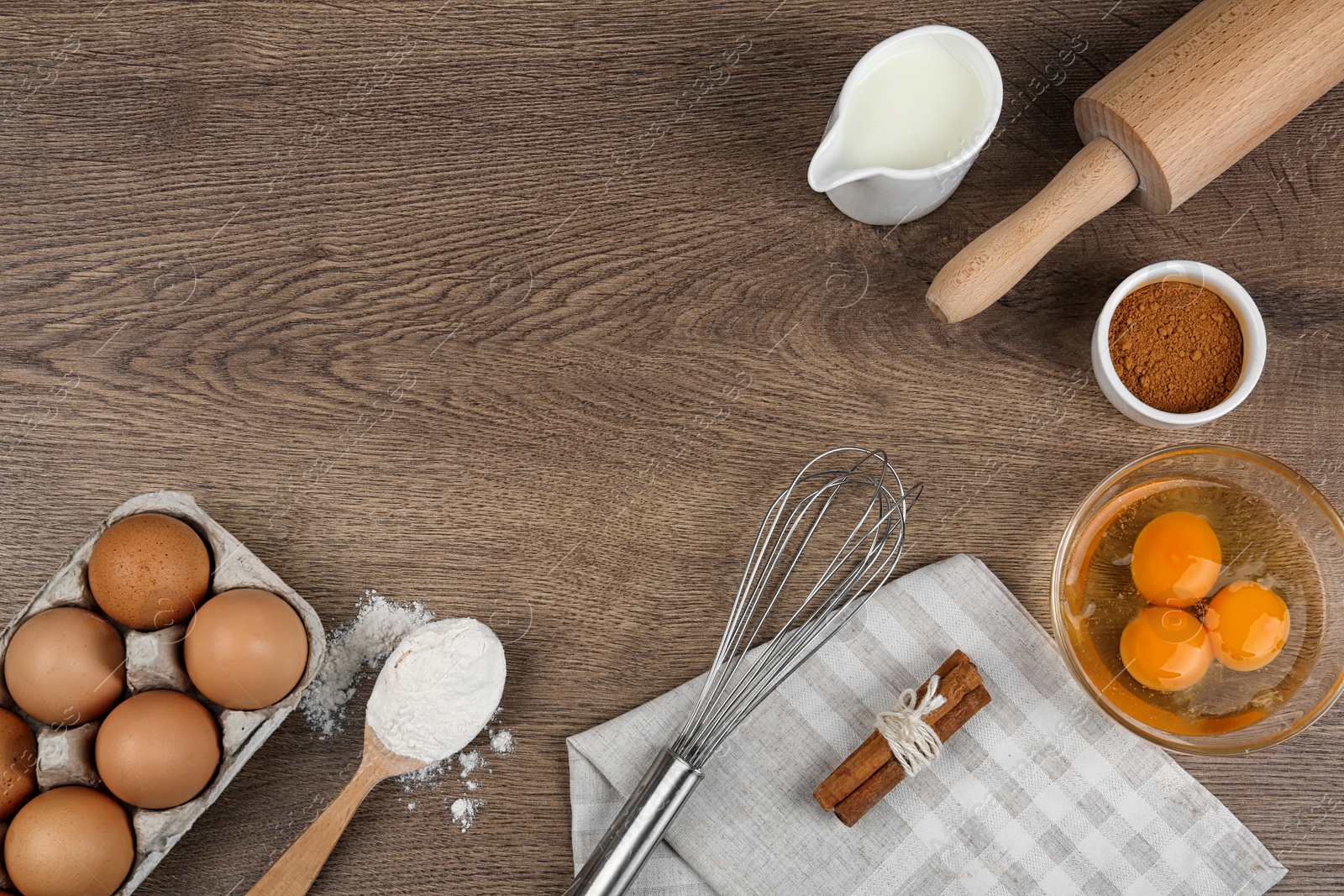 Photo of Flat lay composition with raw eggs and other ingredients on wooden background, space for text. Baking pie