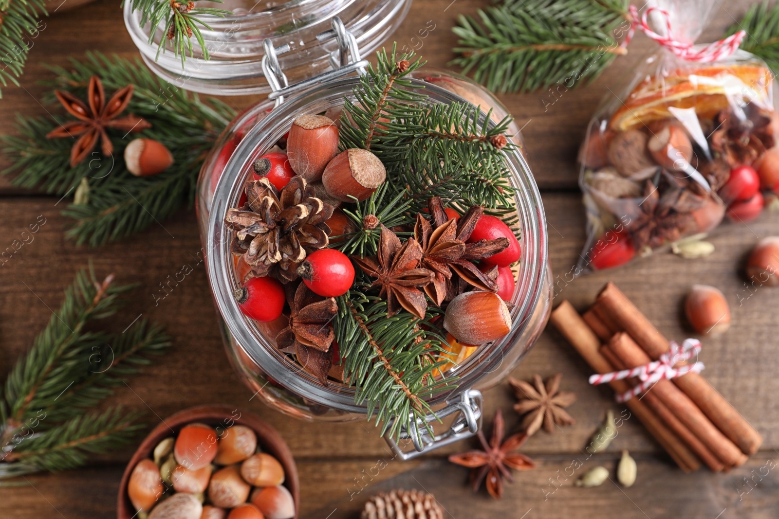 Photo of Aroma potpourri with different spices on wooden table, flat lay