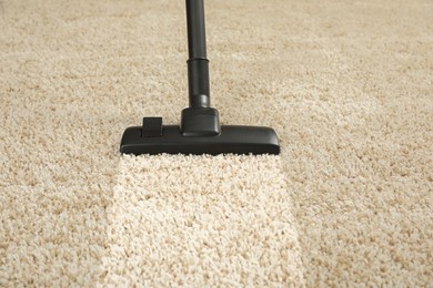 Image of Hoovering carpet with vacuum cleaner. Clean trace on dirty surface