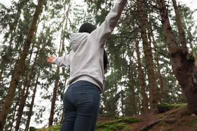 Photo of Woman on walk in beautiful coniferous forest