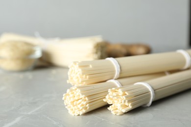 Raw rice noodles on light grey marble table