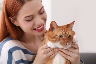 Happy woman with her cute cat at home