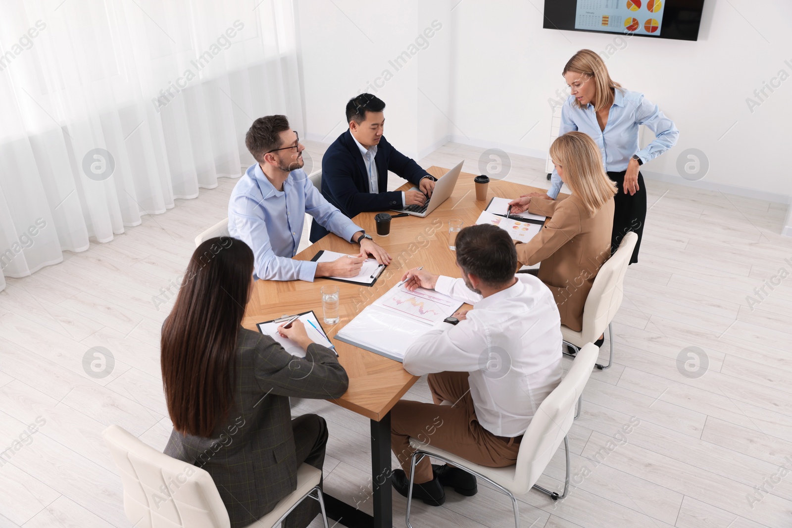 Photo of Businesswoman having meeting with her employees in office