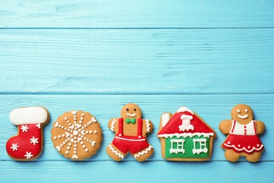 Flat lay composition with tasty homemade Christmas cookies on light blue wooden table, space for text