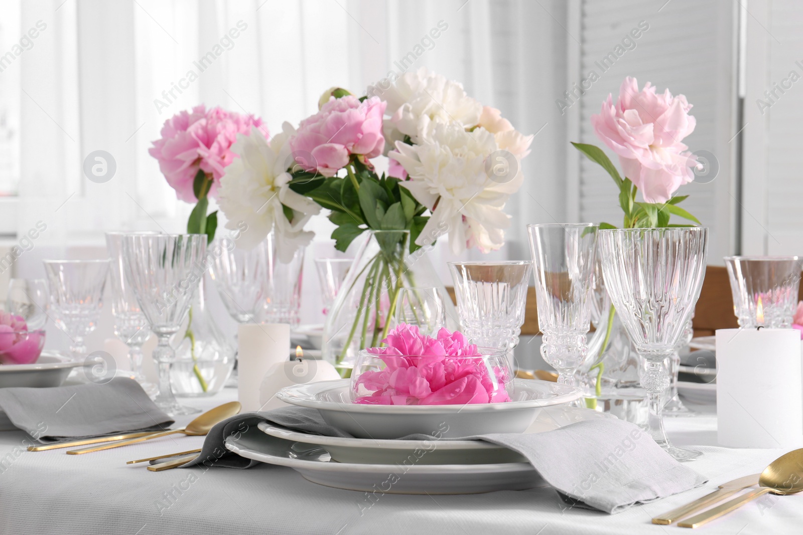 Photo of Stylish table setting with beautiful peonies in dining room