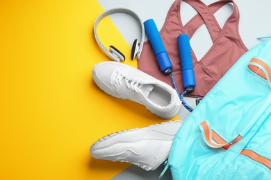 Photo of Flat lay composition with gym bag and sportswear on color background. Space for text