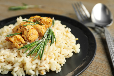 Delicious risotto with chicken on plate, closeup