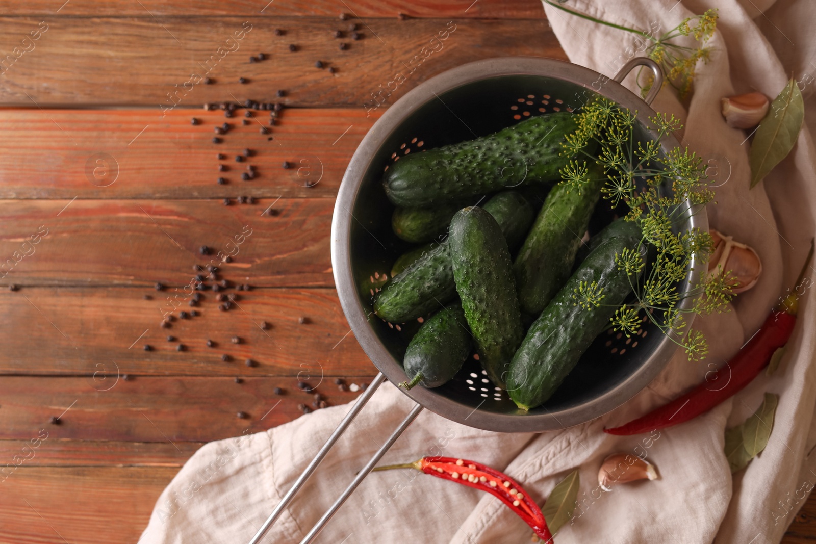 Photo of Fresh cucumbers, dill, garlic and pepper on wooden table, flat lay. Pickling recipe