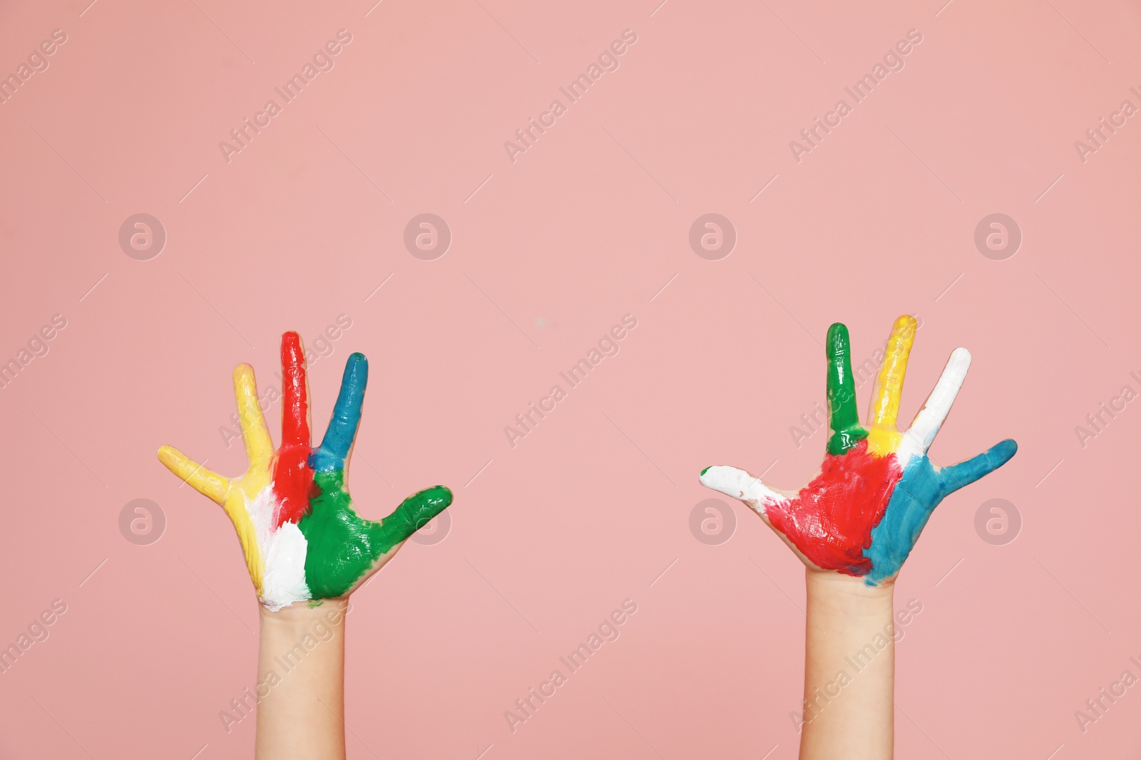 Photo of Little child's painted hands on color background