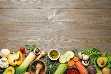 Photo of Flat lay composition with fresh products on wooden table, space for text. Healthy cooking