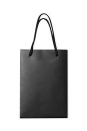 One black paper shopping bag on white background, top view