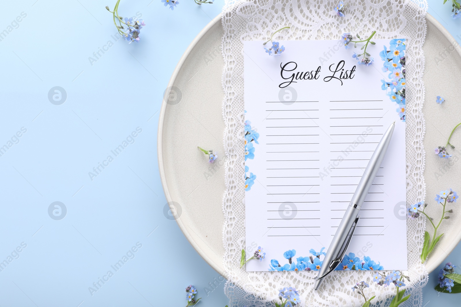 Photo of Plate with guest list, pen, lace and flowers on light blue background, flat lay. Space for text