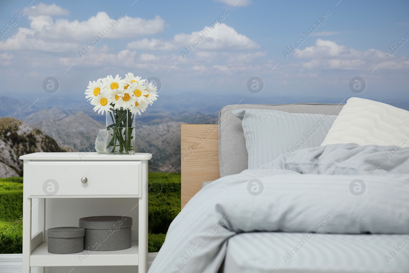 Image of Bedroom interior with comfortable bed and mountain landscape wallpapers