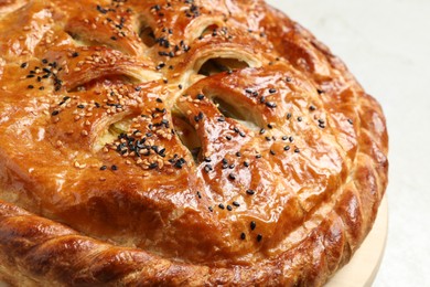 Photo of Tasty homemade pie with filling on light table, closeup