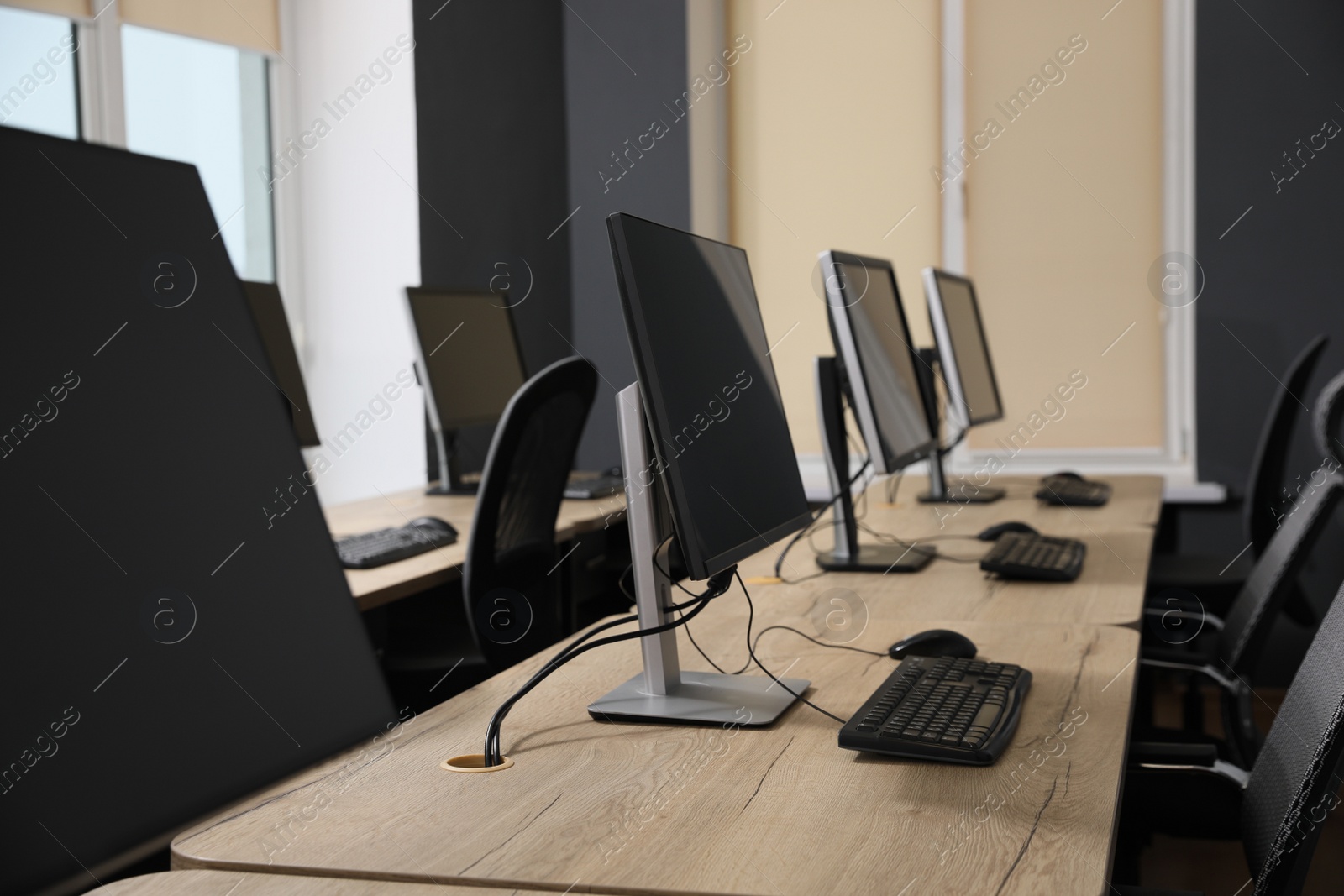 Photo of Many modern computers in open space office