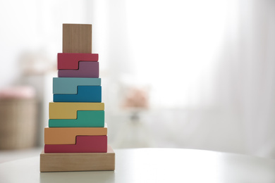 Photo of Colorful wooden blocks on white table in room. Space for text