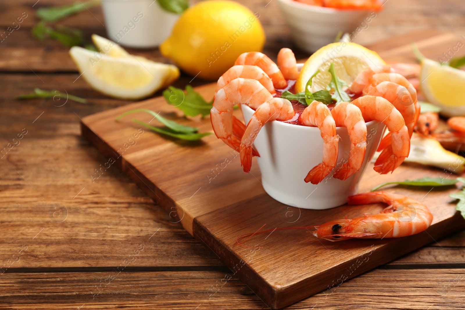 Photo of Delicious shrimp cocktail served on wooden board