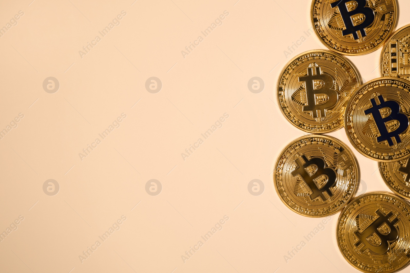 Photo of Bitcoins and space for text on beige background, flat lay. Digital currency