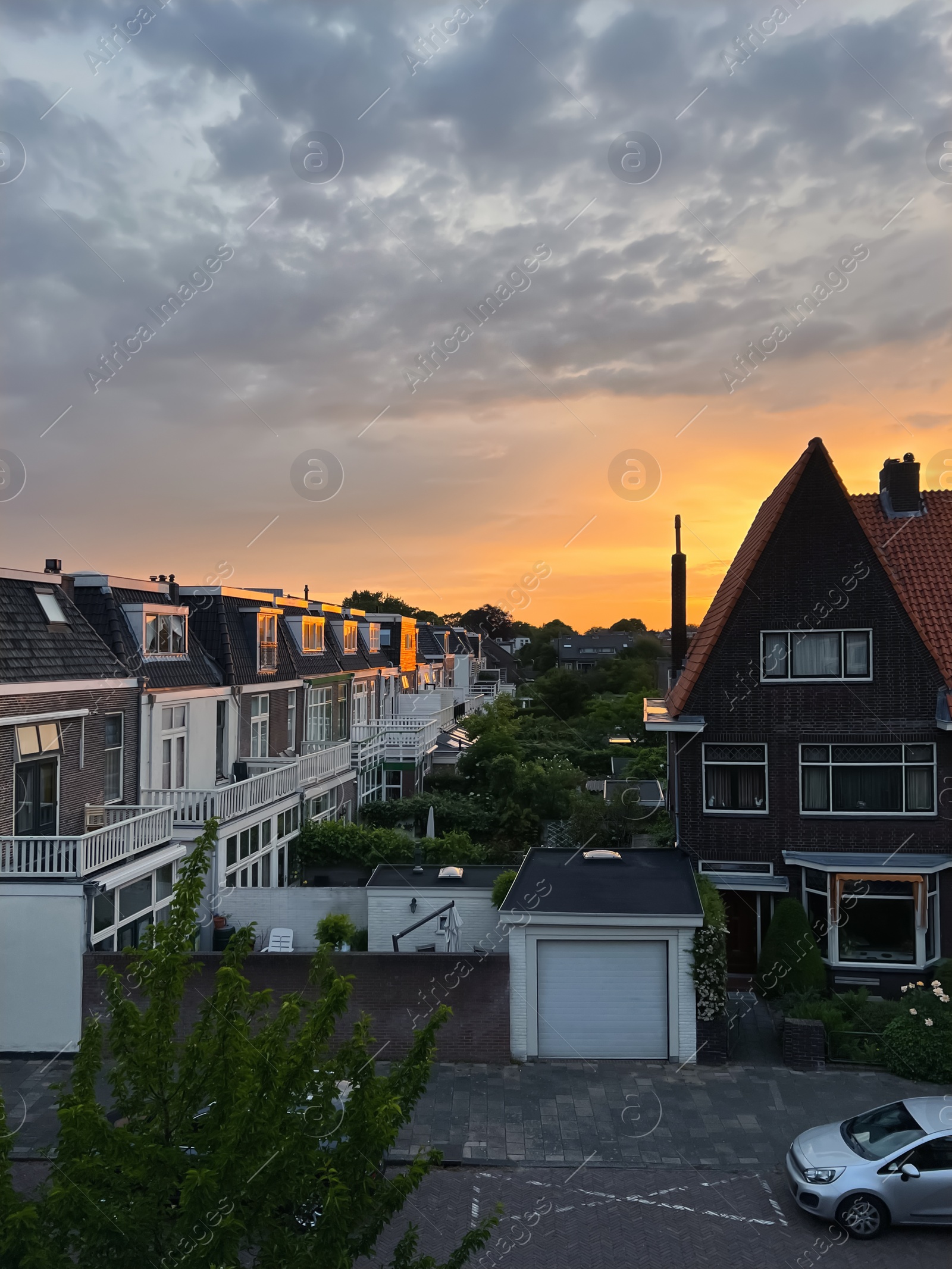 Photo of Picturesque view of city street with beautiful buildings at sunrise