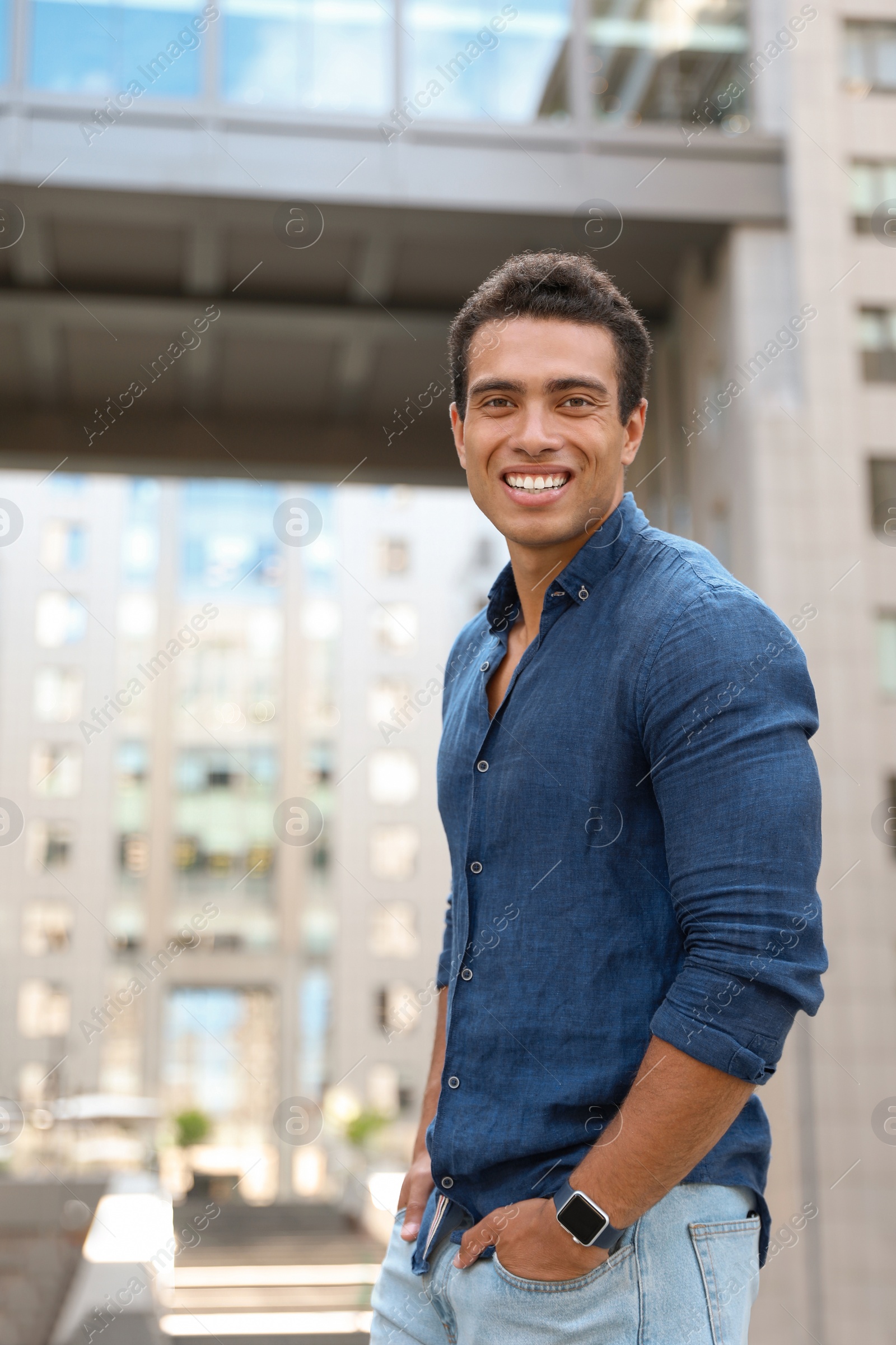 Photo of Portrait of handsome young African-American man on city street