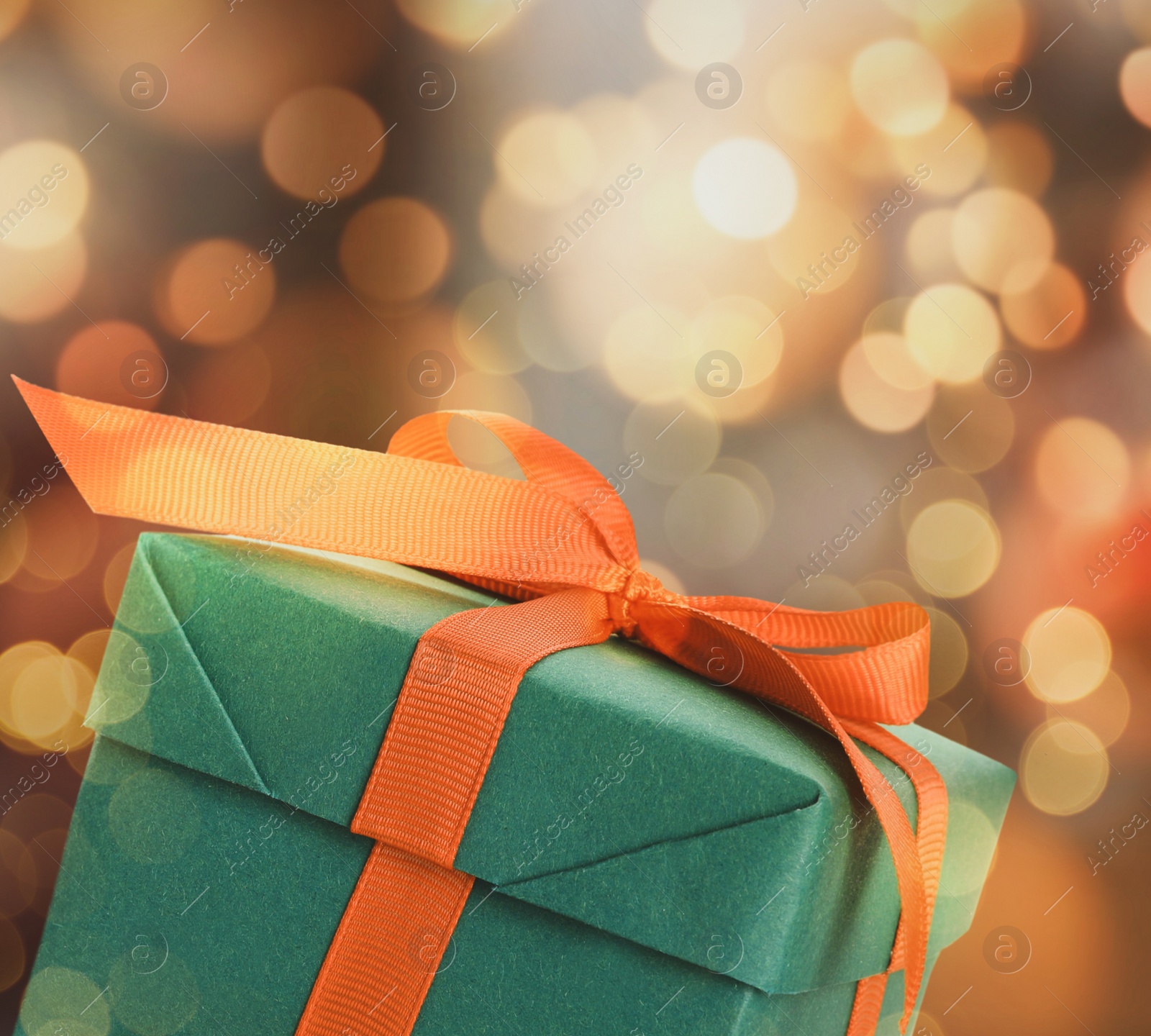 Image of Christmas gift box on blurred background, bokeh effect