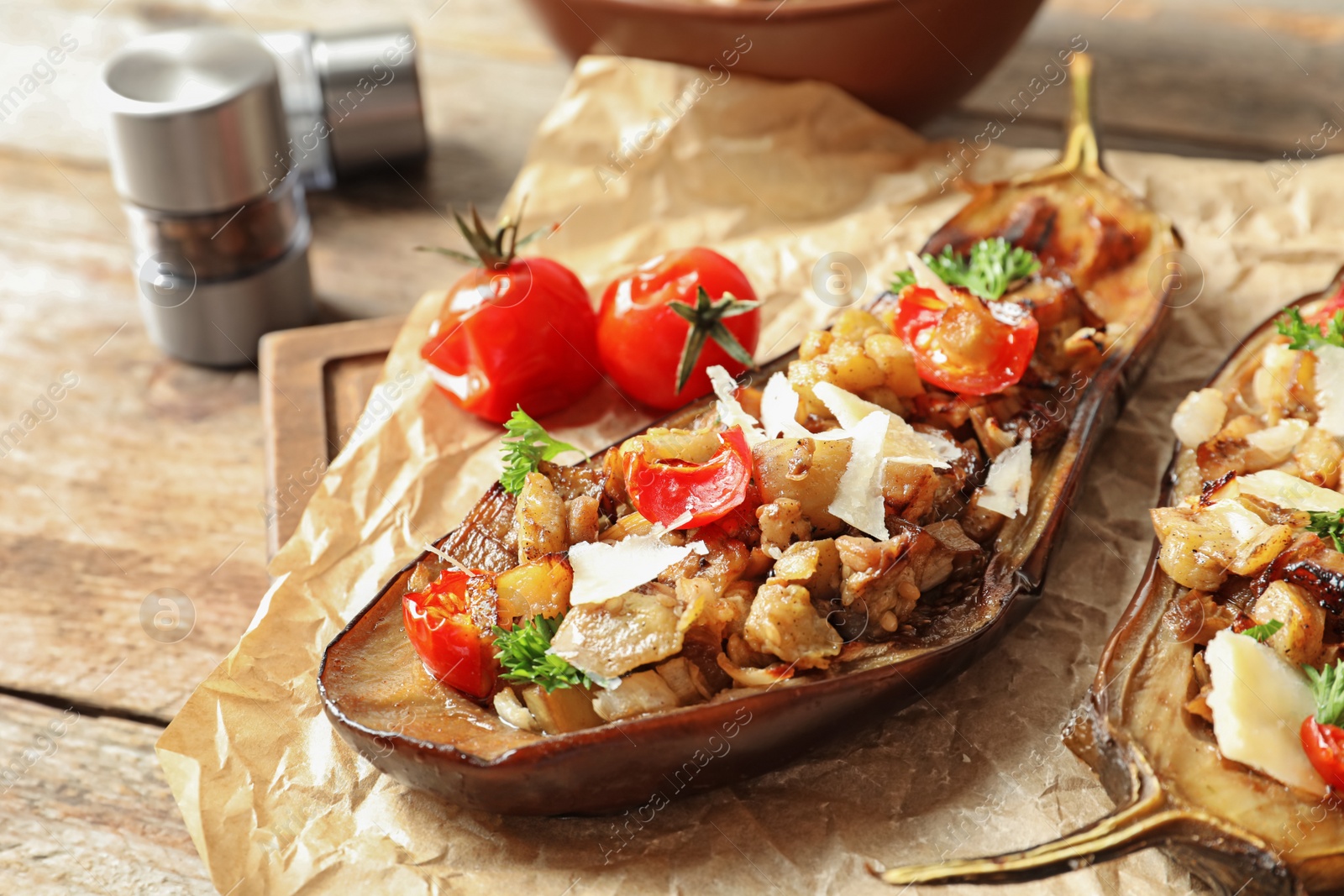 Photo of Tasty stuffed eggplants on wooden table, closeup