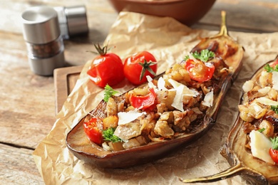 Photo of Tasty stuffed eggplants on wooden table, closeup