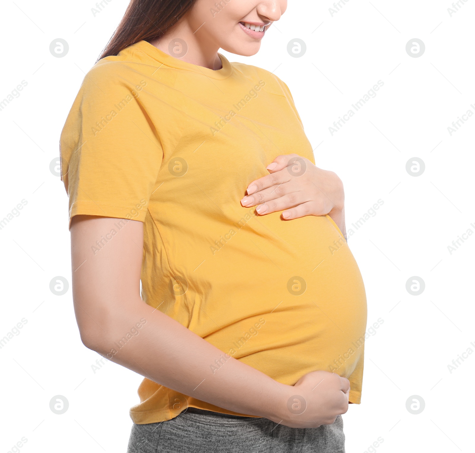 Photo of Young pregnant woman in casual clothes on white background