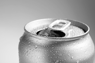 Wet open can on grey background, closeup