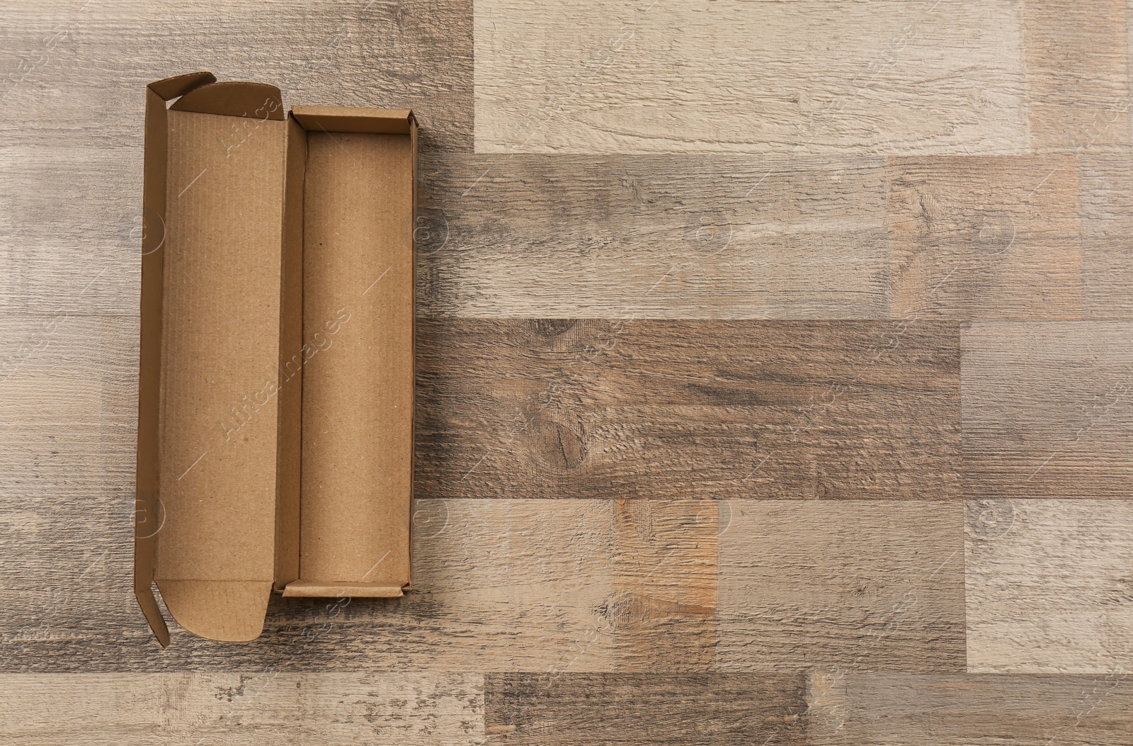 Photo of Cardboard box on wooden floor