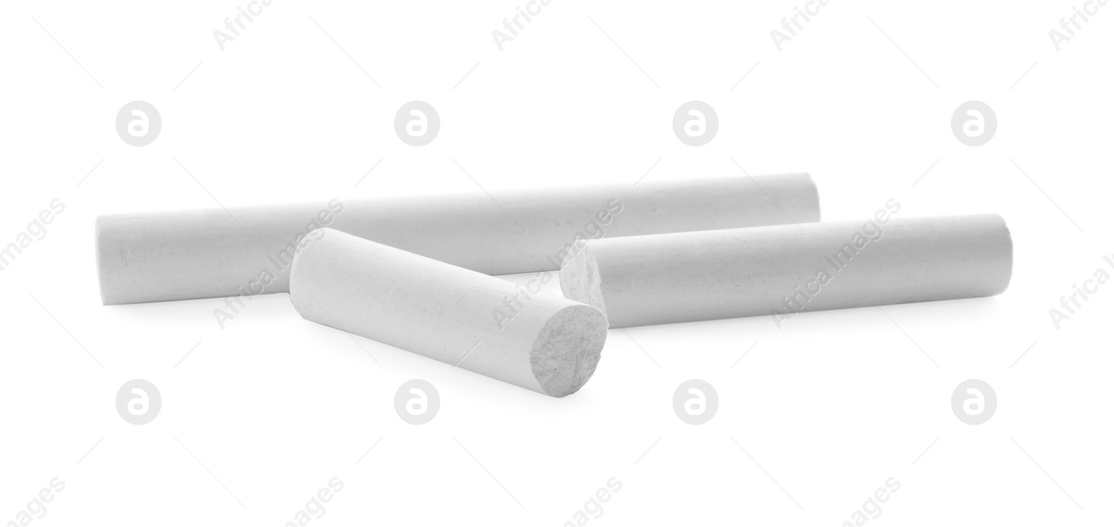 Photo of Small pieces of chalk on white background