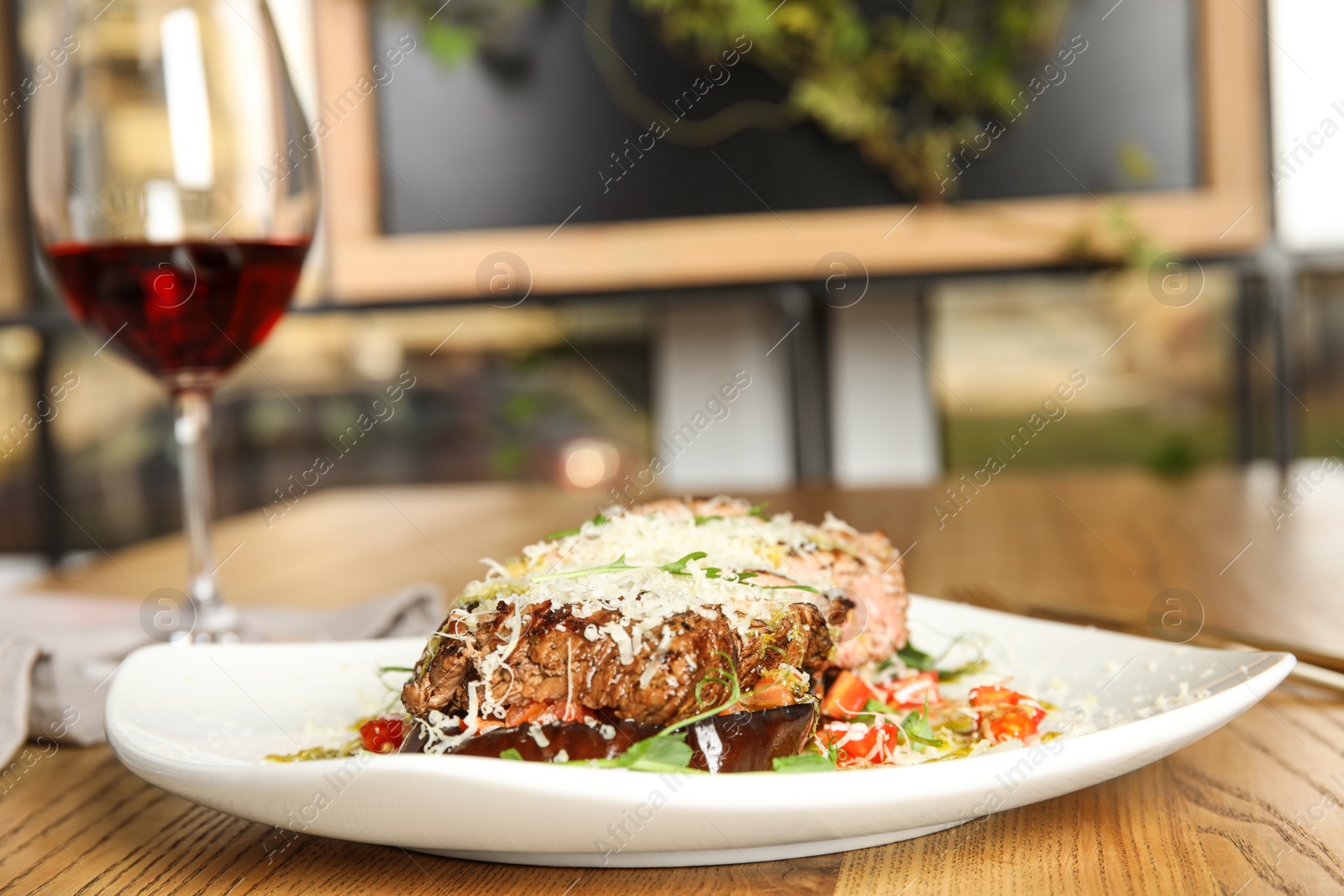 Photo of Delicious roasted meat served on wooden table indoors. Space for text