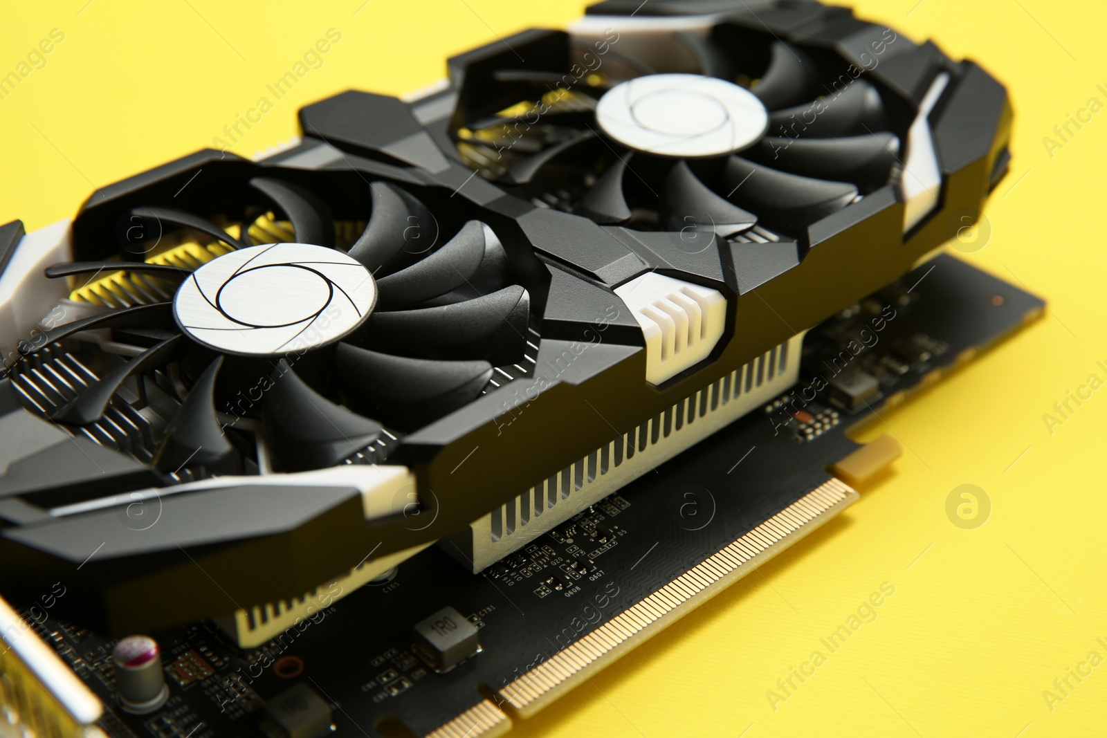 Photo of Computer graphics card on yellow background, closeup