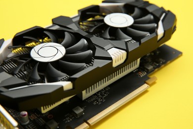 Photo of Computer graphics card on yellow background, closeup