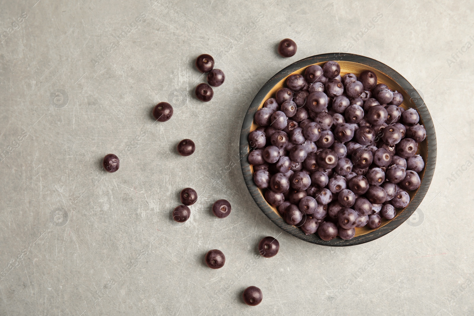 Photo of Plate with fresh acai berries on table, top view