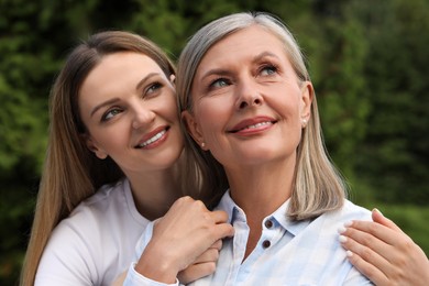 Photo of Happy mature mother and her daughter in park