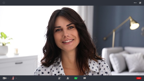 Woman communicating with coworkers from home using video chat, view through camera